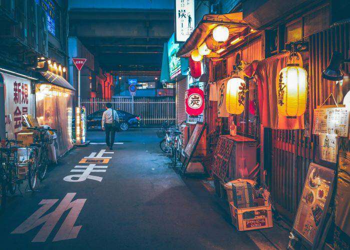 An izakaya in Japan at night, lighting up the evening with its lanterns.